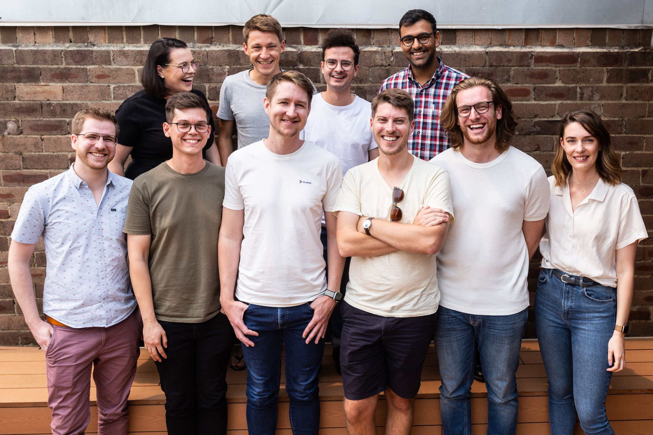 The OCSEE team standing against a brick wall.